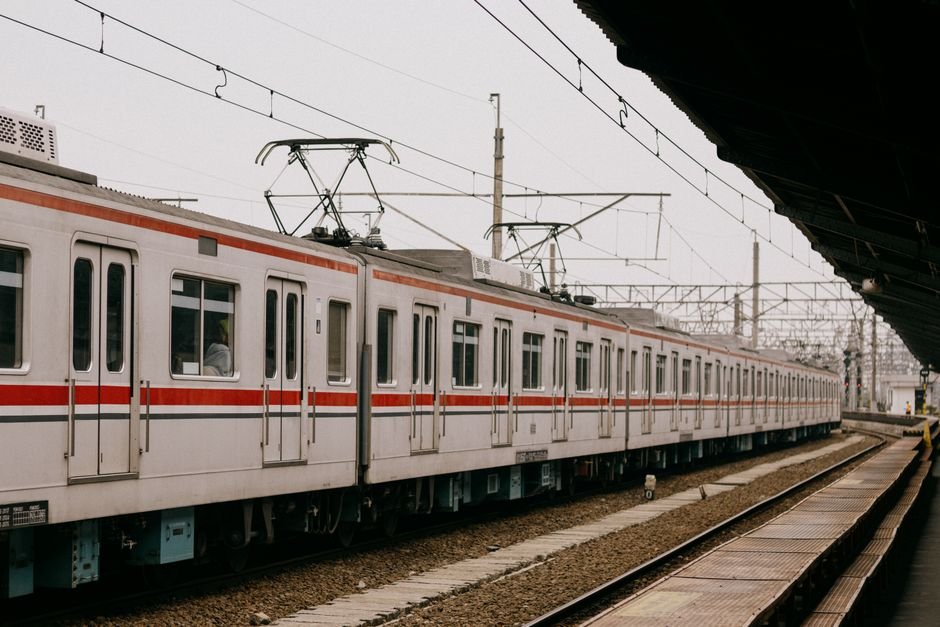 Metro train roof with pantograph in contact with the overhead catenary wire