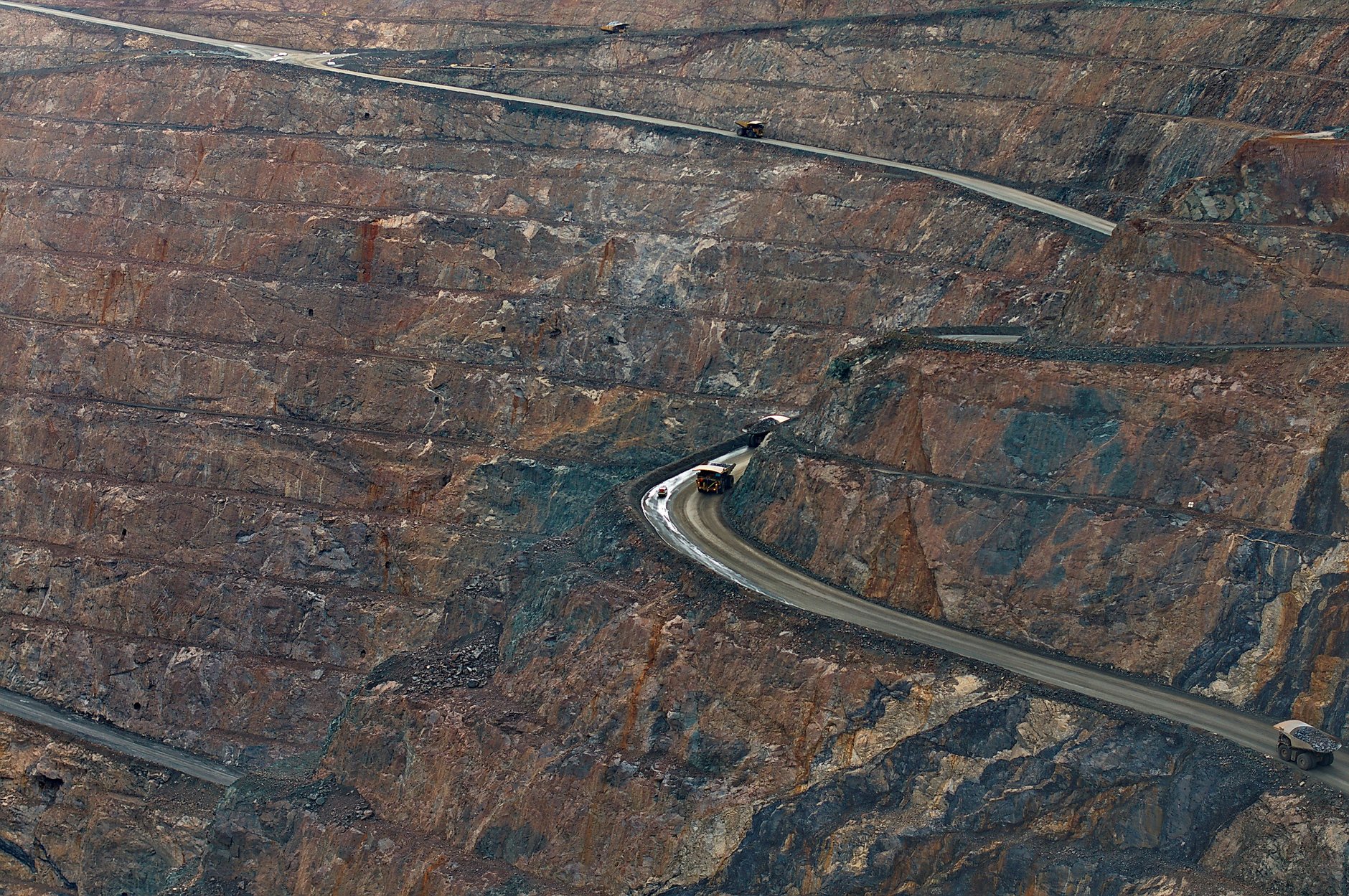 Large mining haul truck operating at night on a pit road